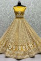 Yellow Bridal Lehenga Choli in Embroidered Net